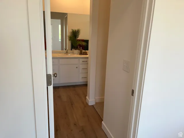 Hall featuring dark wood-style floors and baseboards