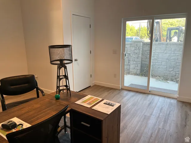 Home office with light wood-type flooring