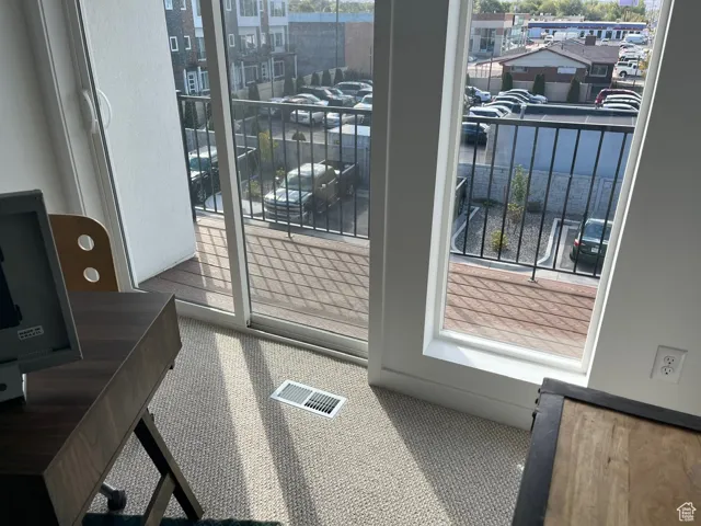 Doorway featuring carpet flooring