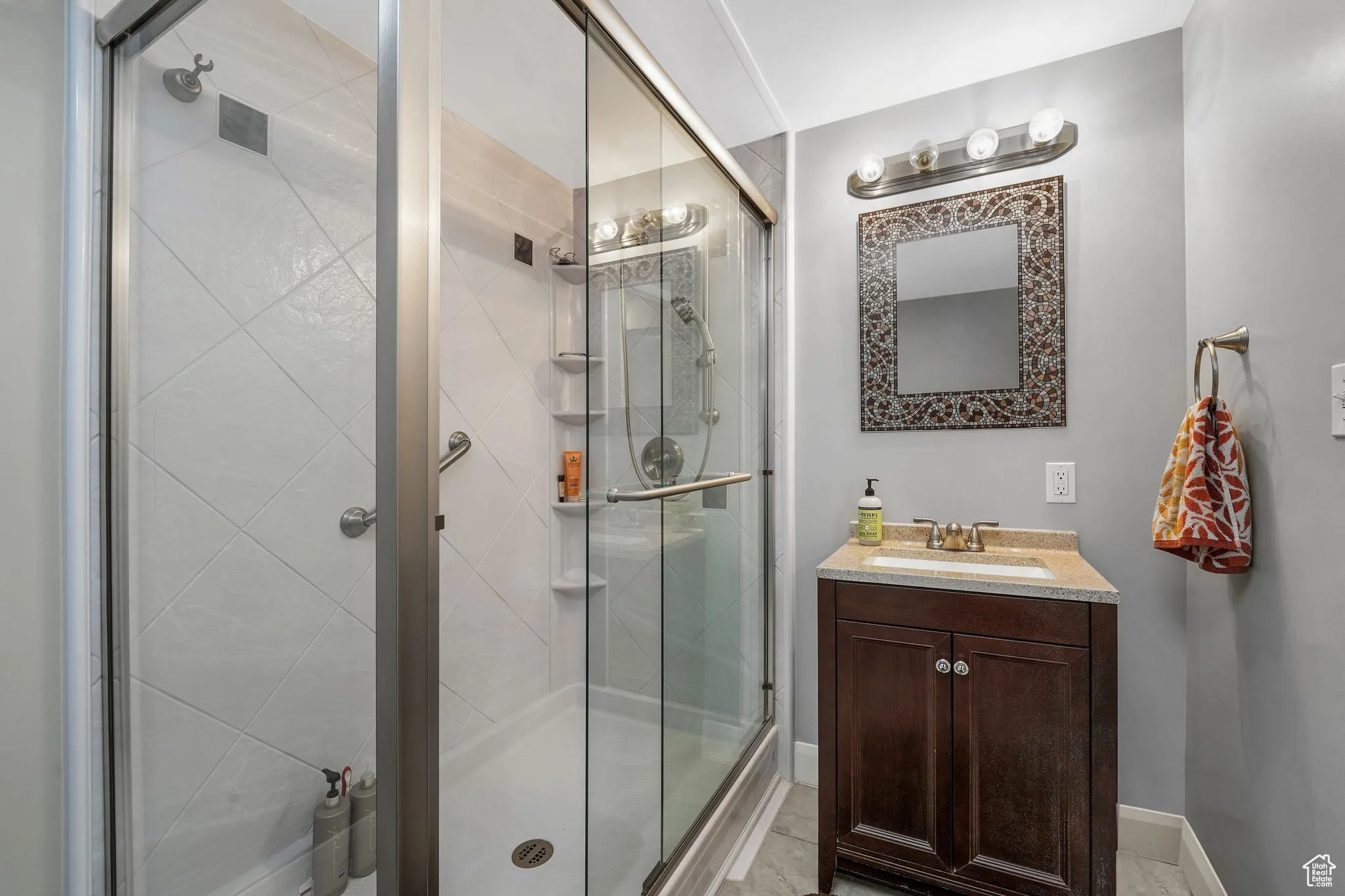 Full bathroom featuring vanity and a stall shower