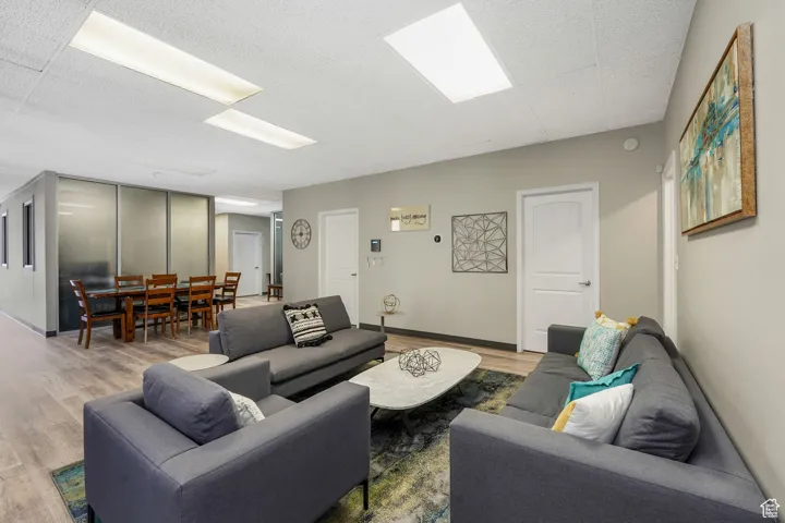 Living area with wood finished floors and baseboards