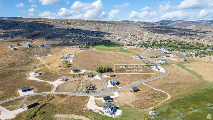Aerial view of property and surrounding area with a mountainous background and rural landscape