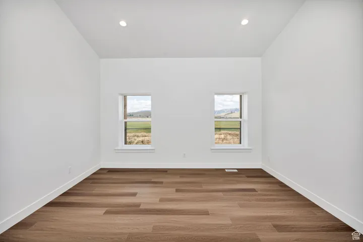 Unfurnished room featuring healthy amount of natural light, light wood finished floors, and recessed lighting