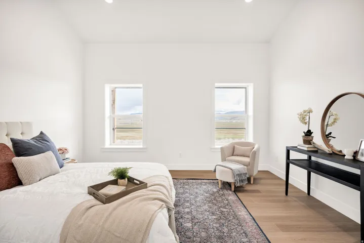Bedroom with wood finished floors, recessed lighting, and multiple windows