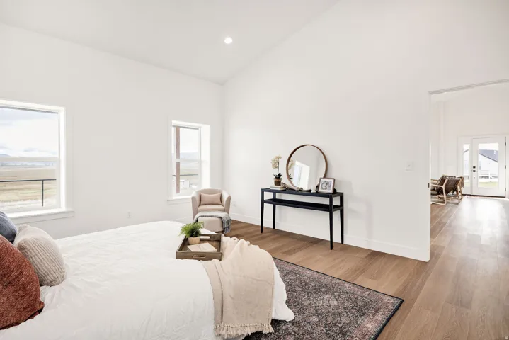 Bedroom featuring light wood-type flooring, vaulted ceiling, and recessed lighting