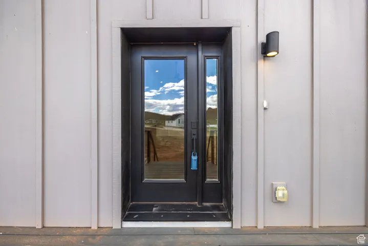 Property entrance featuring board and batten siding
