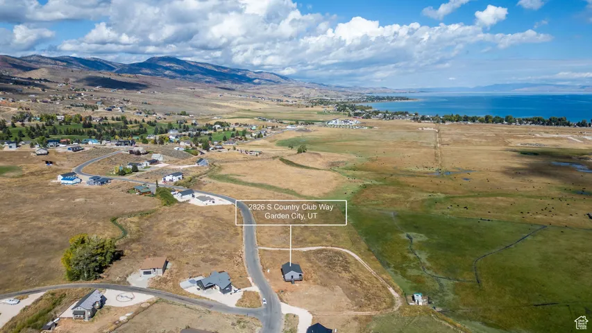 Aerial view of property's location featuring a water and mountain view
