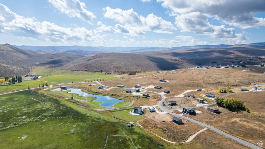 Aerial view of property's location with rural landscape and a water and mountain view
