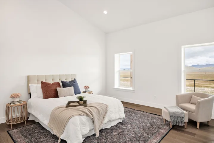 Bedroom featuring wood finished floors, vaulted ceiling, and recessed lighting