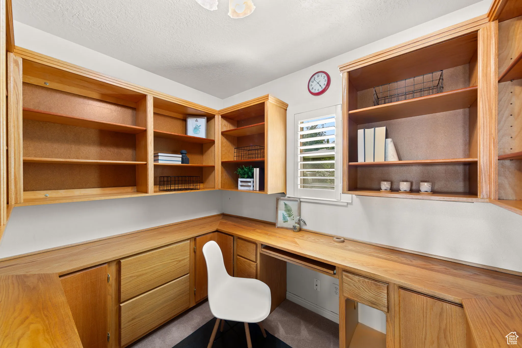 Office space with built in study area and a textured ceiling