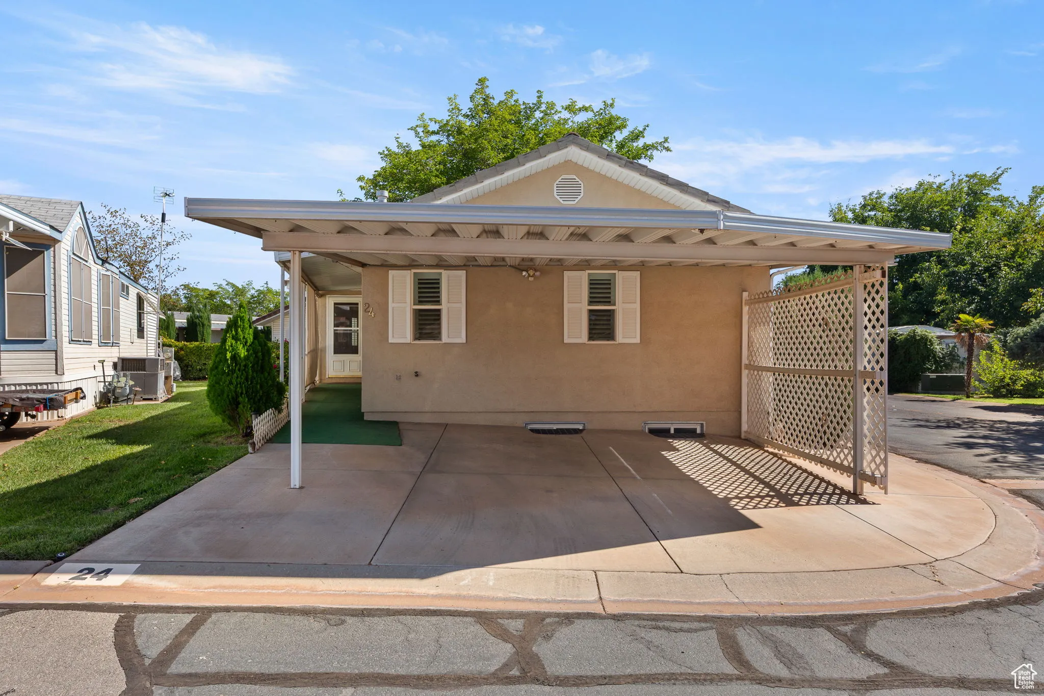 Rear view of house with stucco siding and a yard