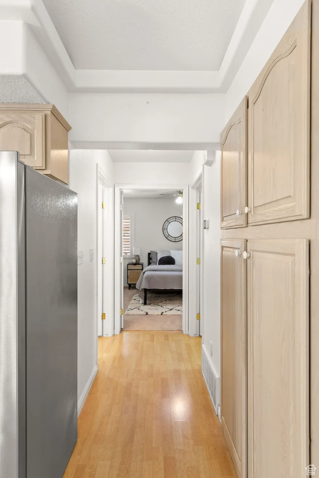 Corridor with light wood finished floors and baseboards