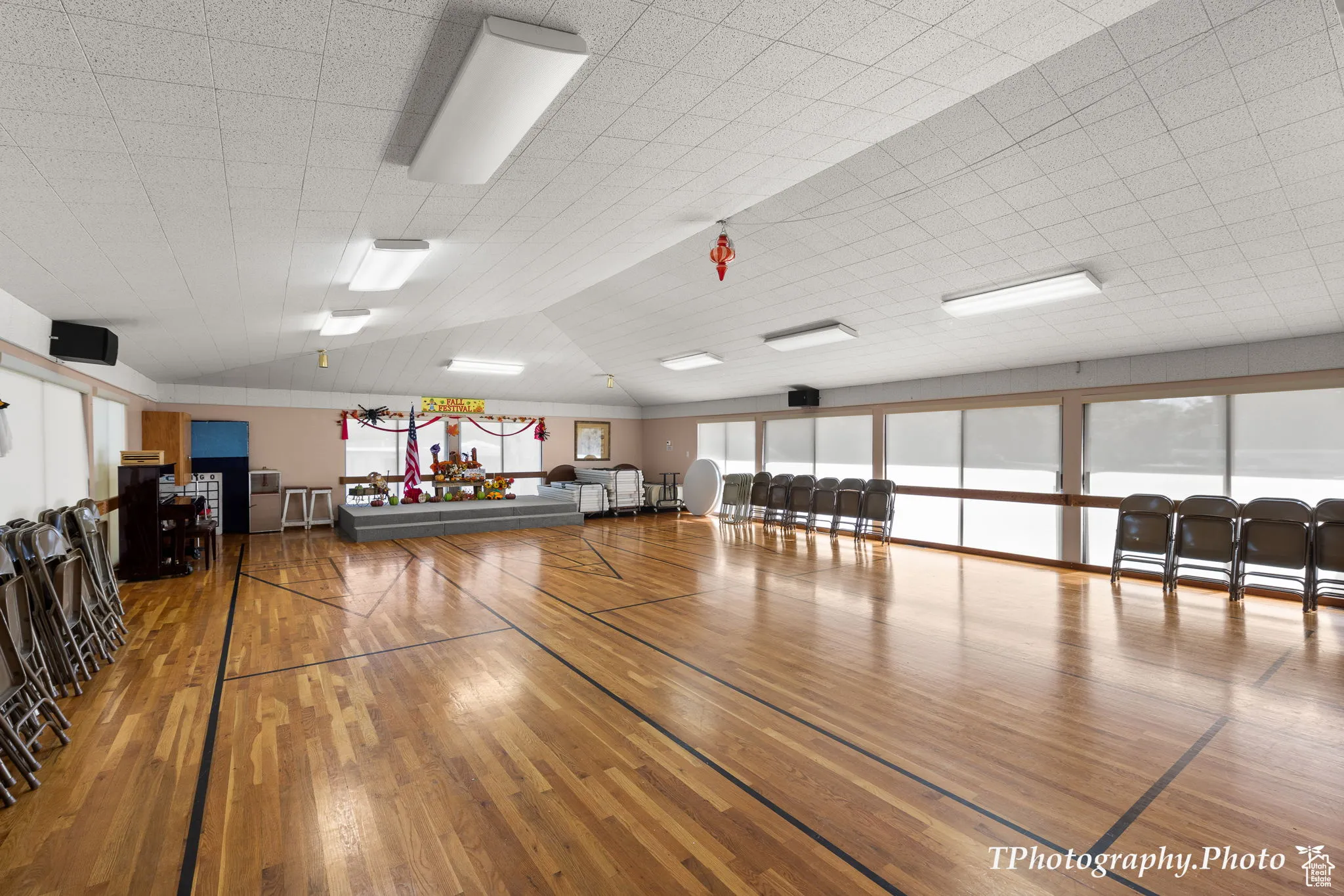 Exercise room with light wood-type flooring and lofted ceiling