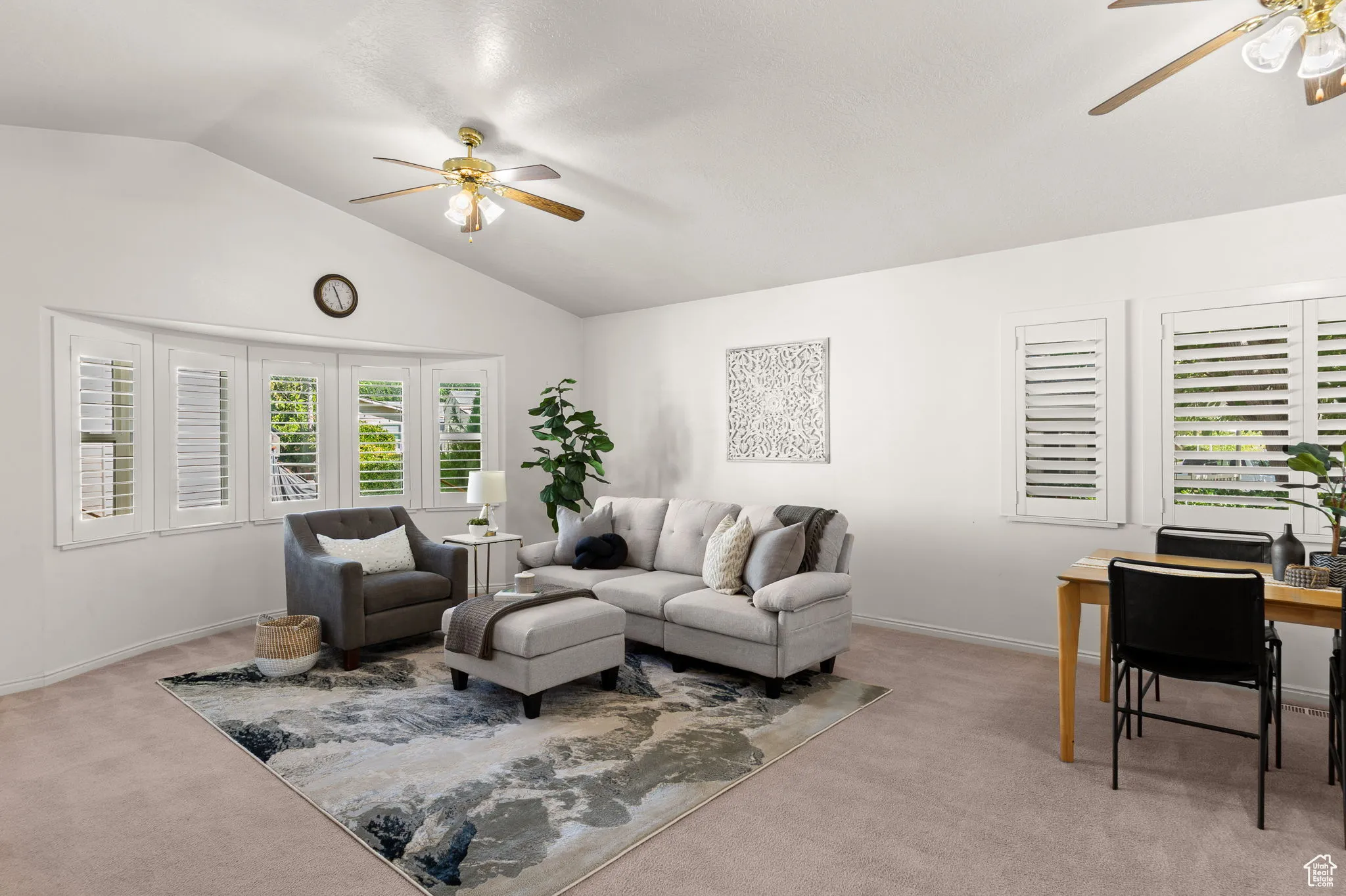 Living room with ceiling fan, carpet, lofted ceiling, and an office area
