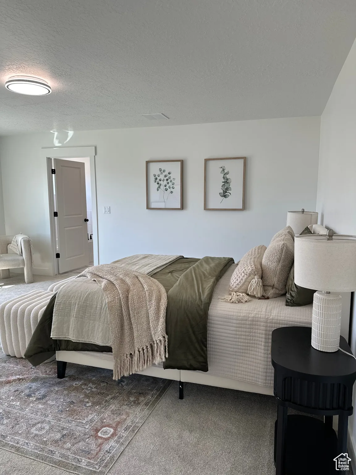 Bedroom with carpet flooring and a textured ceiling