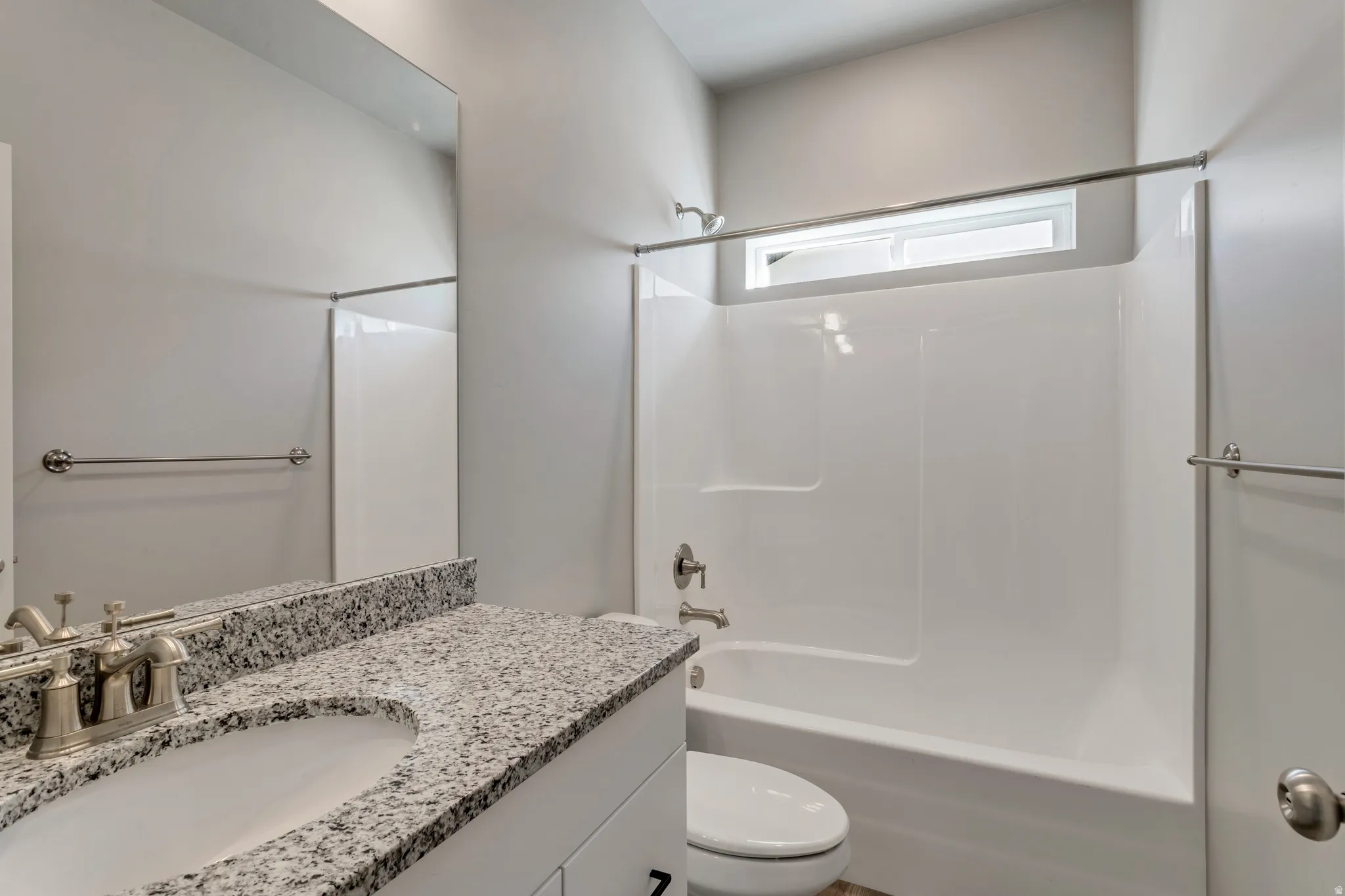 Full bathroom with washtub / shower combination and vanity