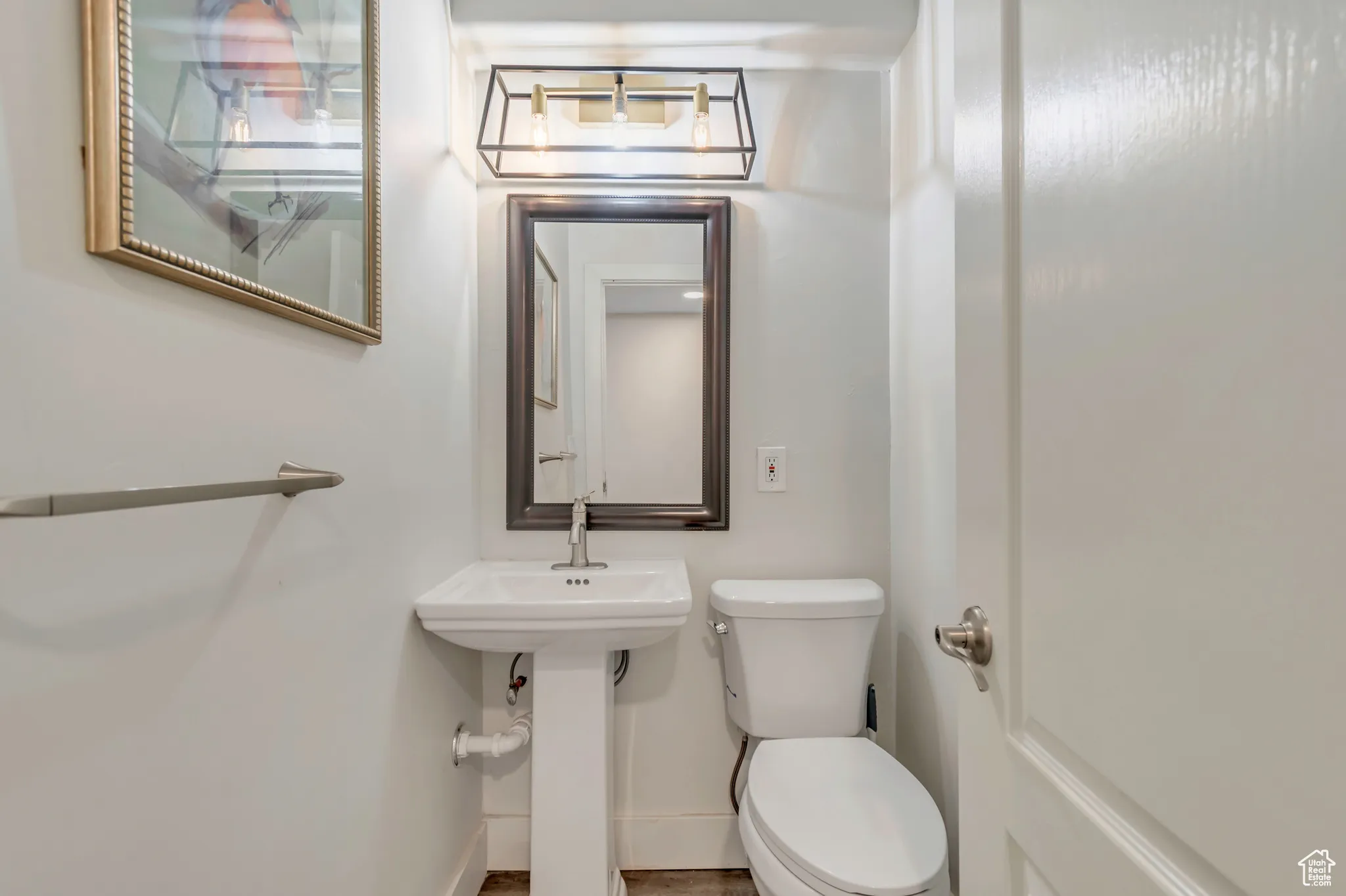 Half bath with toilet and baseboards