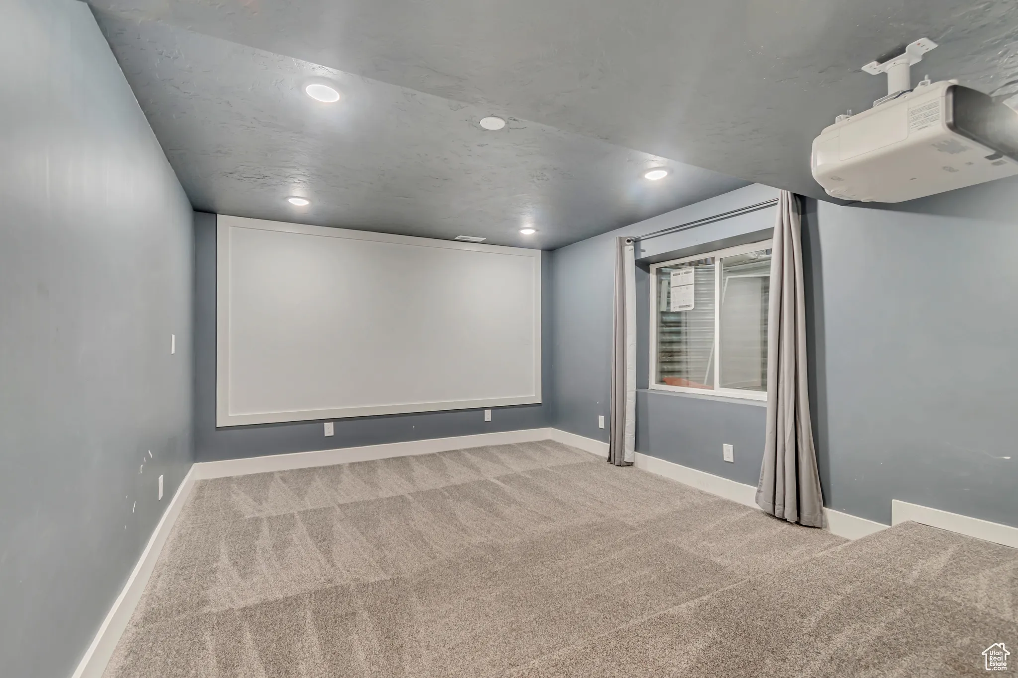Cinema featuring light colored carpet, recessed lighting, and a textured ceiling