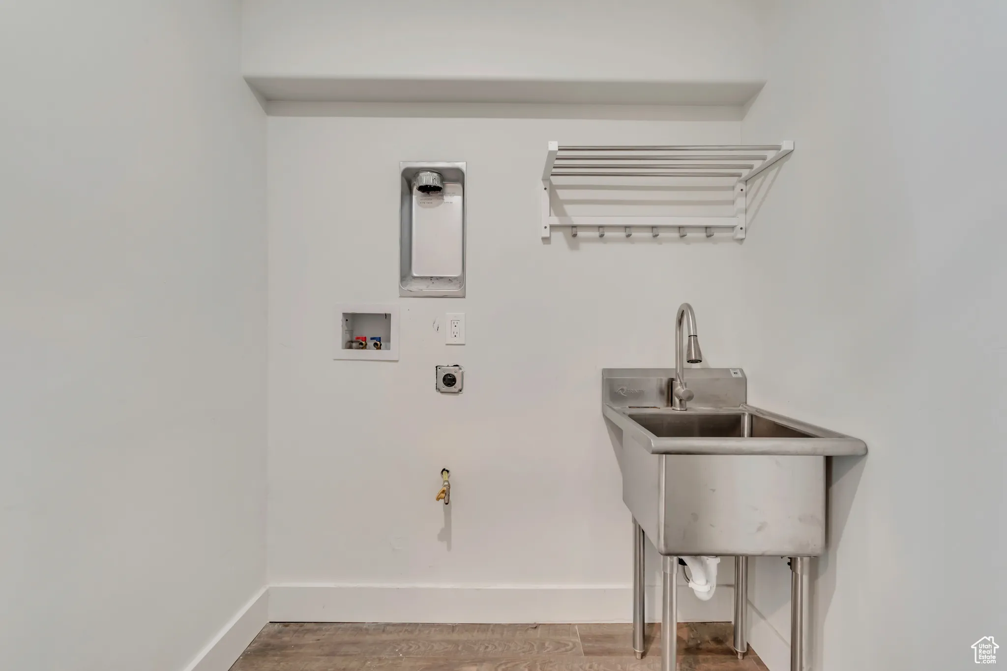 Laundry room featuring washer hookup, wood finished floors, and hookup for an electric dryer