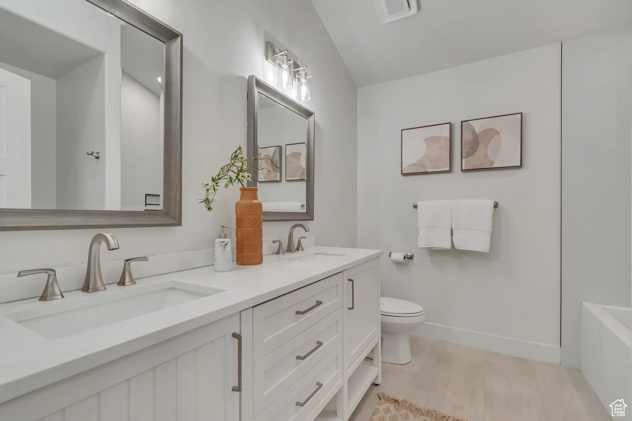 Primary bathroom with Full bathroom featuring double vanity and shower / bath combination