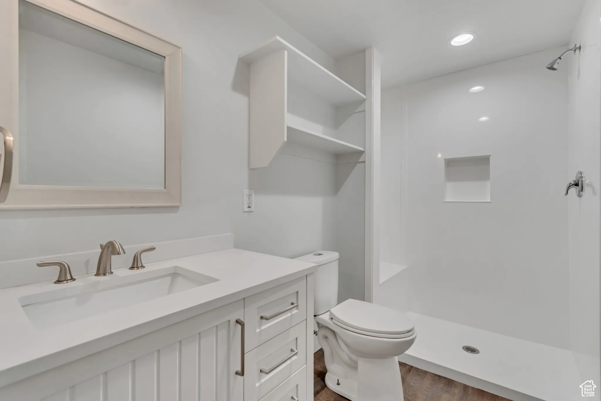 Full bathroom with vanity, a shower stall, recessed lighting, and dark wood-type flooring