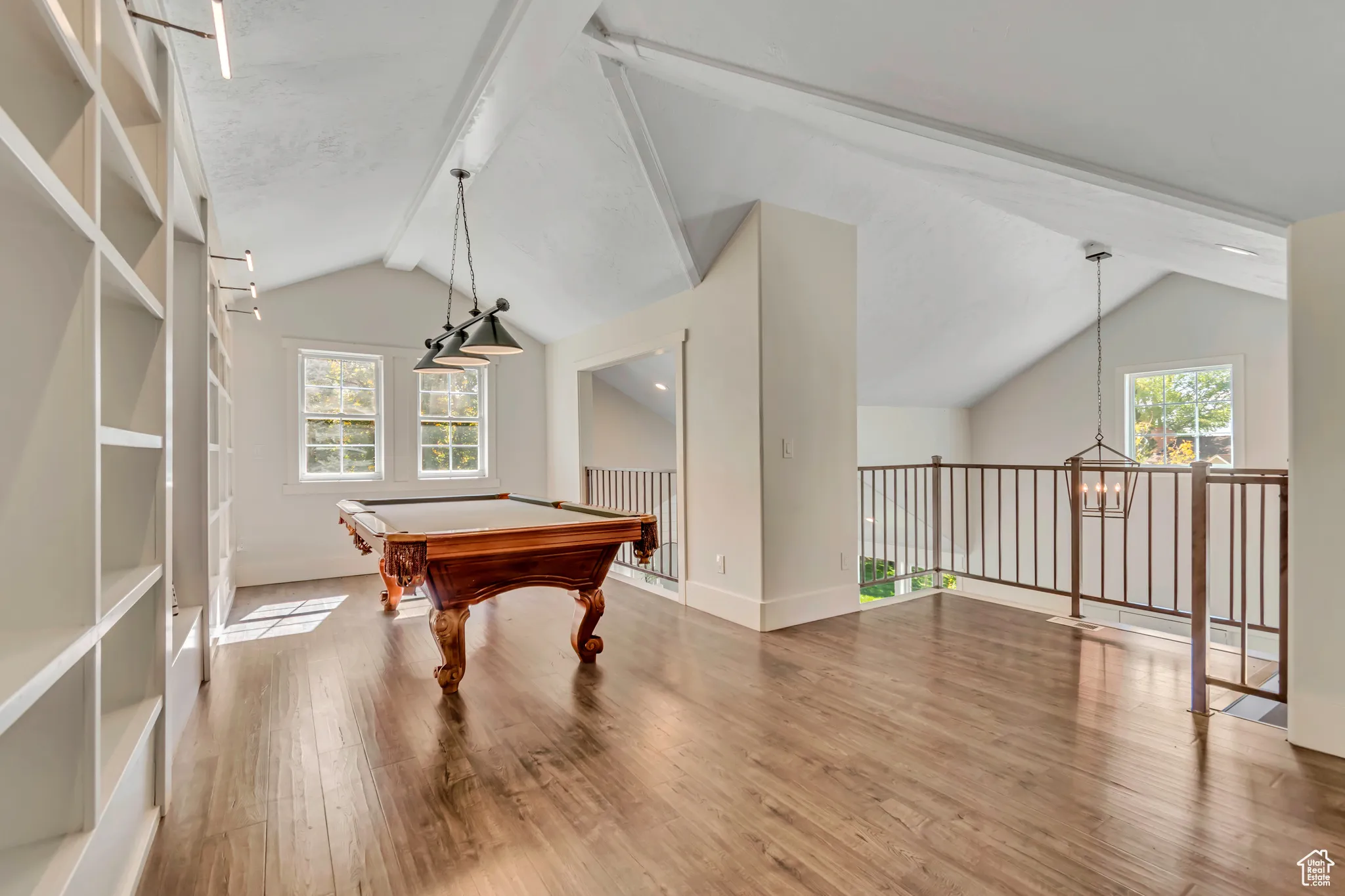 Game room featuring wood finished floors, a chandelier, and billiards table