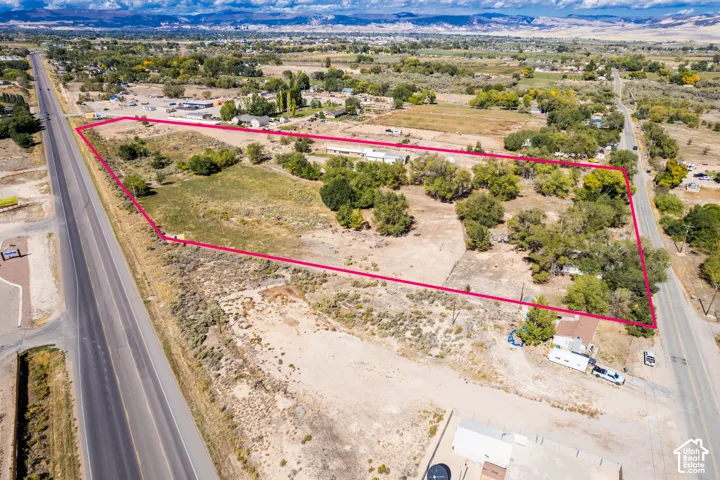 Expansive parcel featuring mature trees, natural vegetation, and prominent mountain backdrops