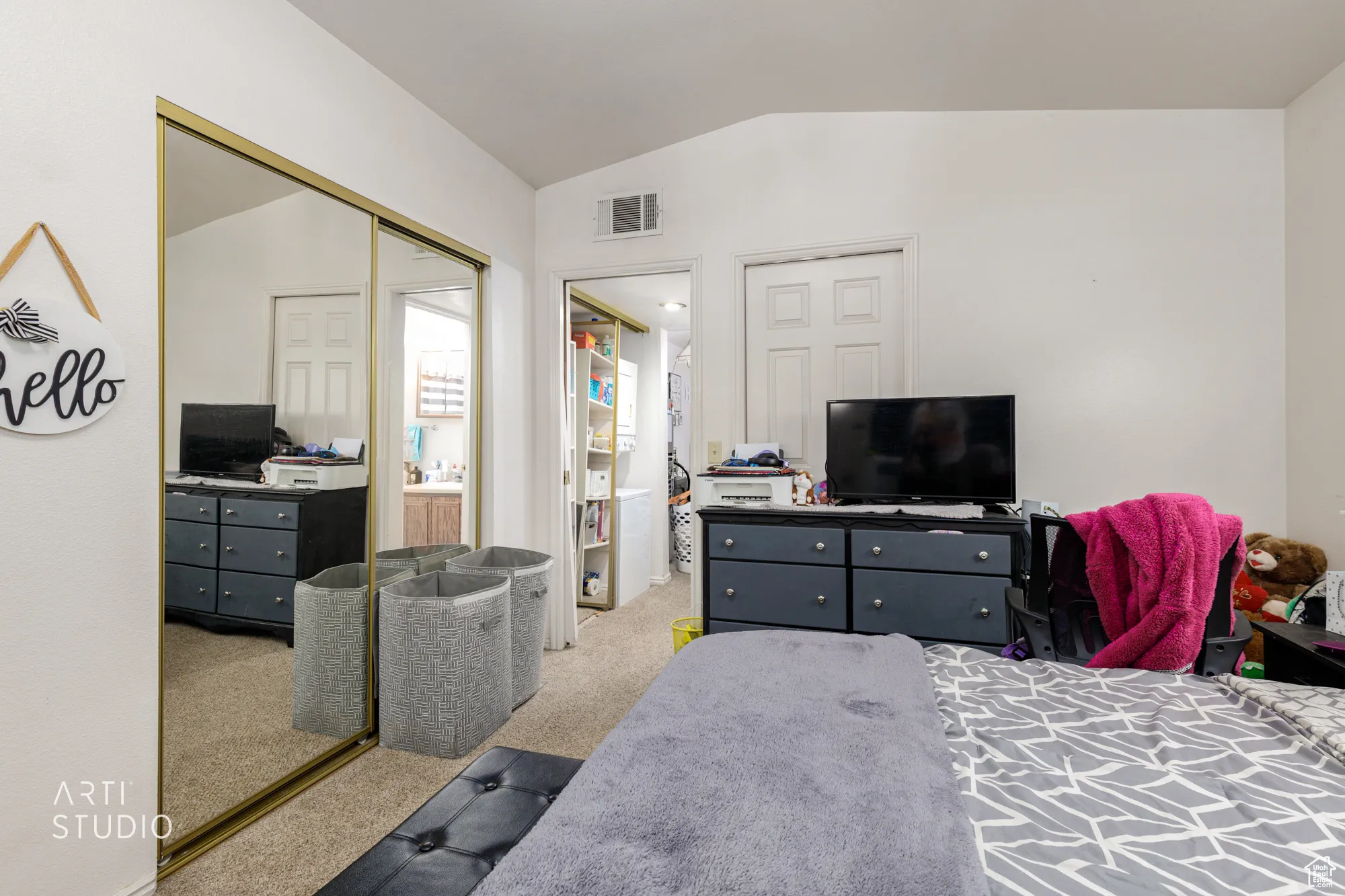 Bedroom with vaulted ceiling, carpet flooring, and a closet