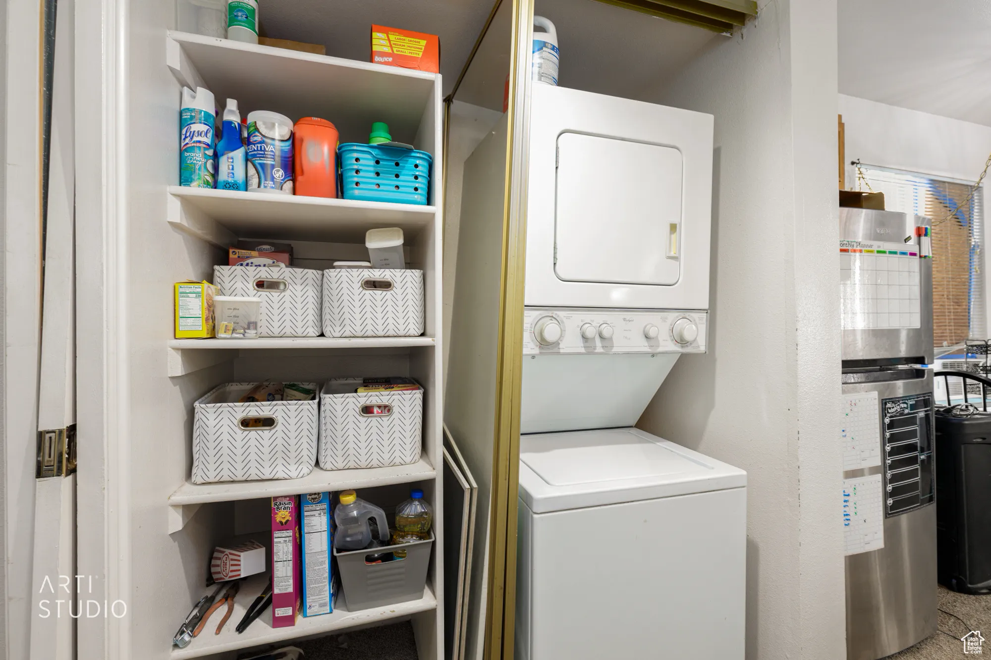 Washroom with stacked washer and clothes dryer