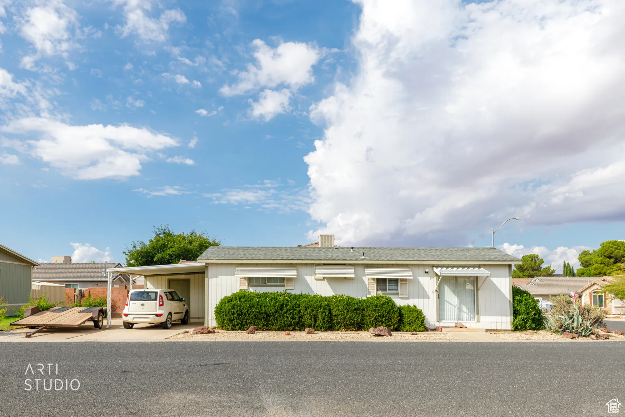 Ranch-style house featuring an attached carport