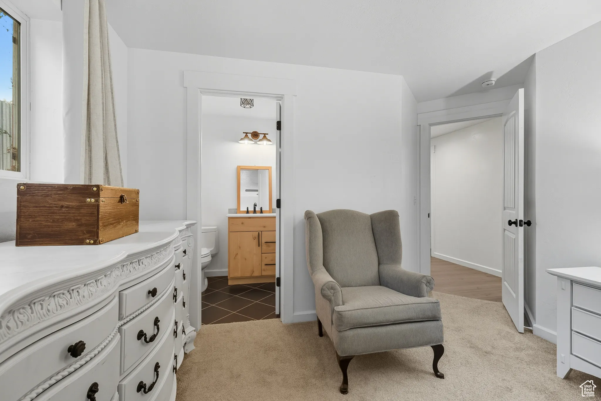 Living area with light colored carpet and baseboards