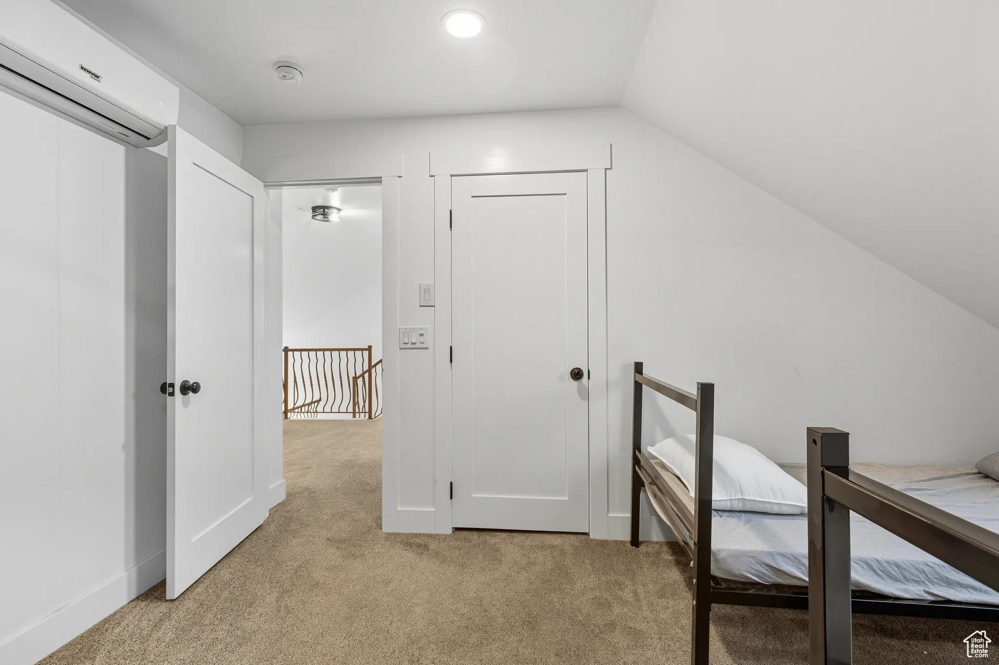 Unfurnished office featuring light colored carpet and a wall mounted AC