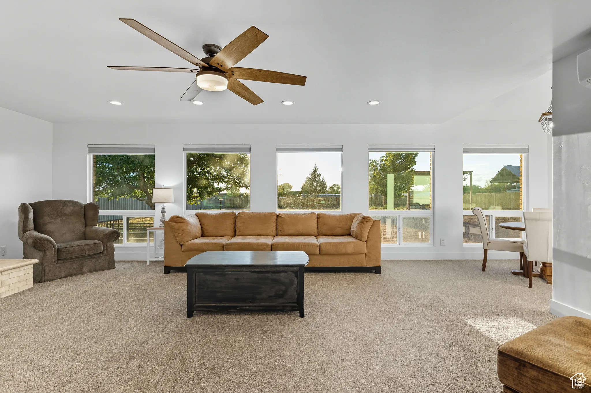 Living area featuring light carpet, recessed lighting, and a ceiling fan