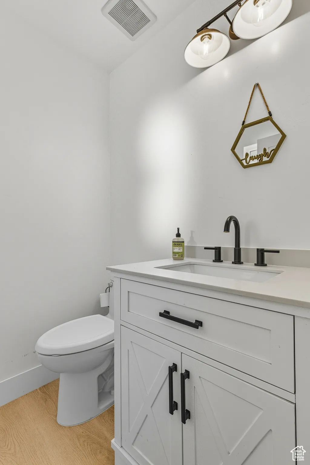 Bathroom featuring vanity and light wood-style floors