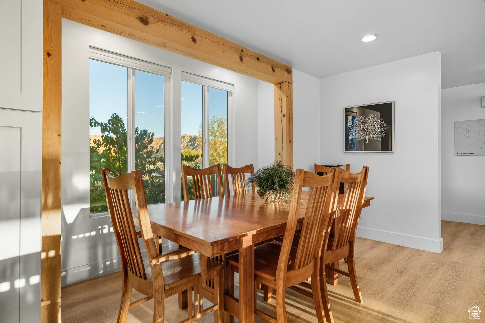Dining space with light wood-style flooring and recessed lighting
