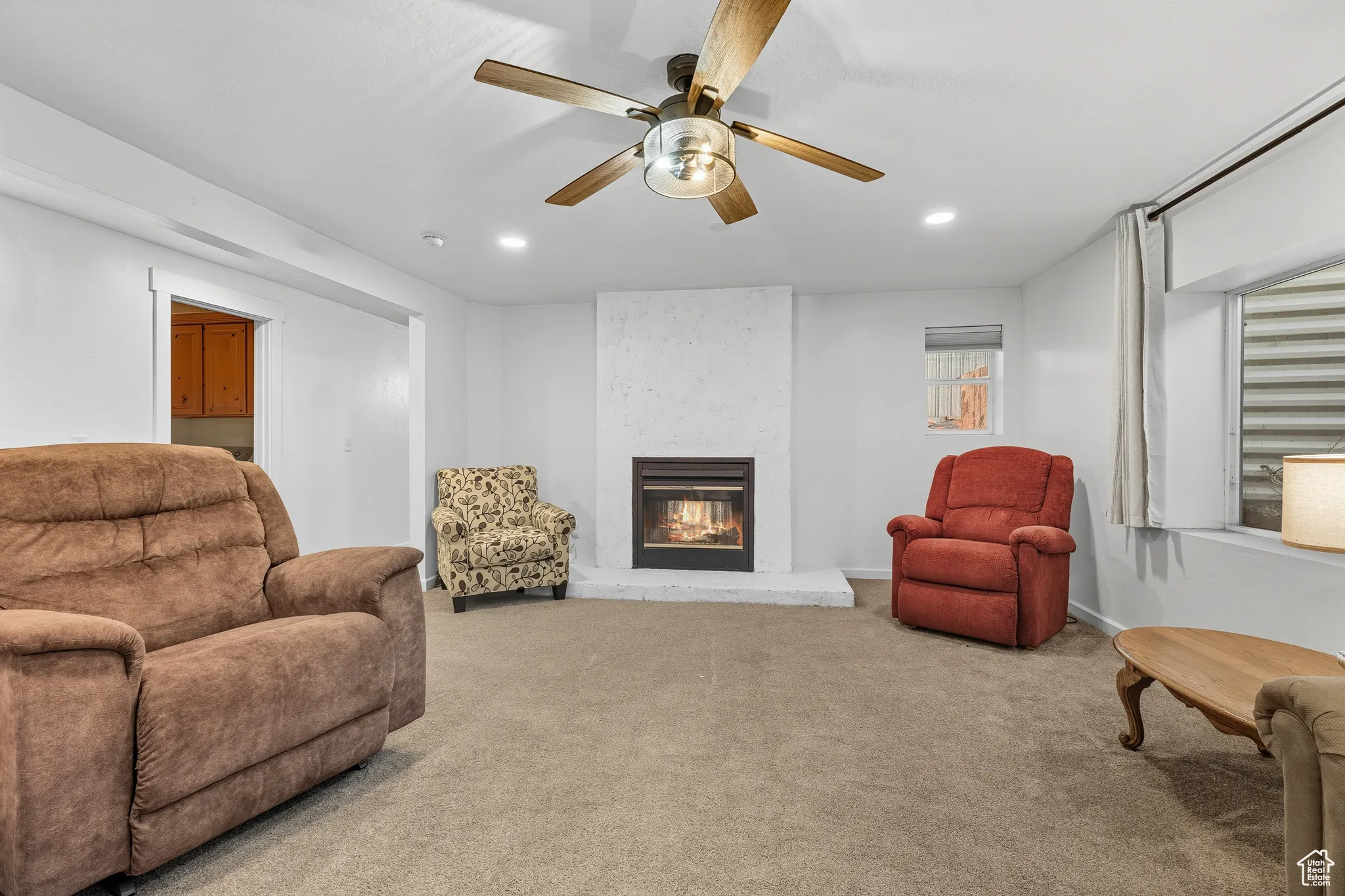 Living area with carpet, a fireplace, recessed lighting, and ceiling fan