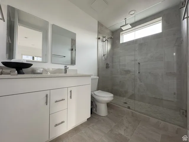 Full bathroom with vanity and a shower stall