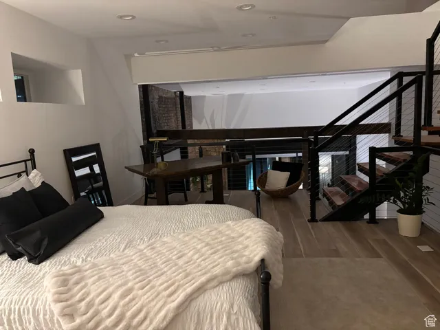 Twilight Bedroom 2 with wood finished floors and recessed lighting.
