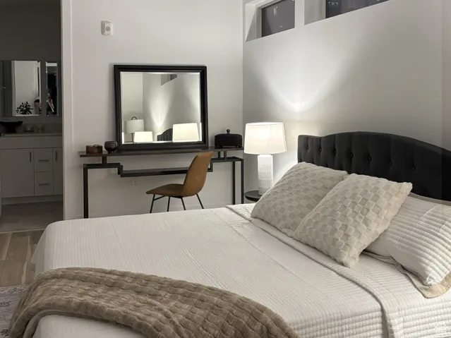 Bedroom Suite with wood finished floors and ensuite bathroom