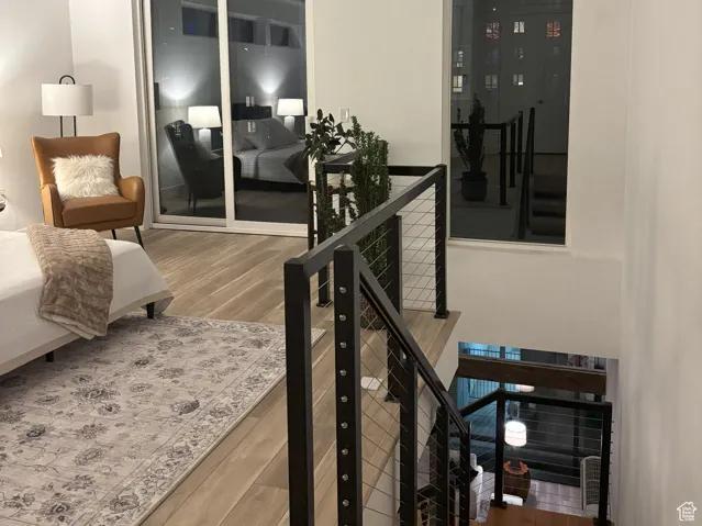 Stairway with wood finished floors and recessed lighting