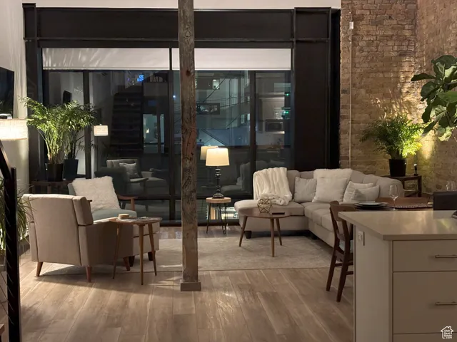 Twilight living room featuring brick wall