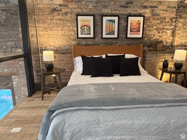 Bedroom 2 with exposed brick walls.