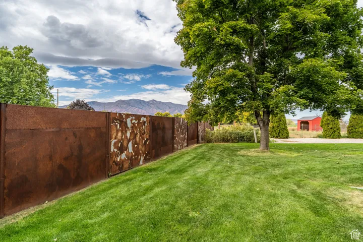 Fenced backyard with a mountain view