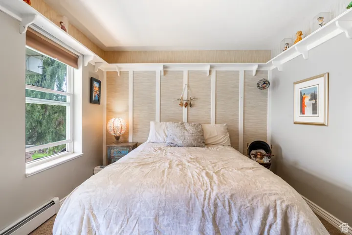 Bedroom featuring a baseboard heating unit