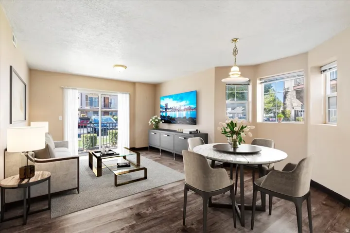 Dining space featuring a textured ceiling and wood finished floors