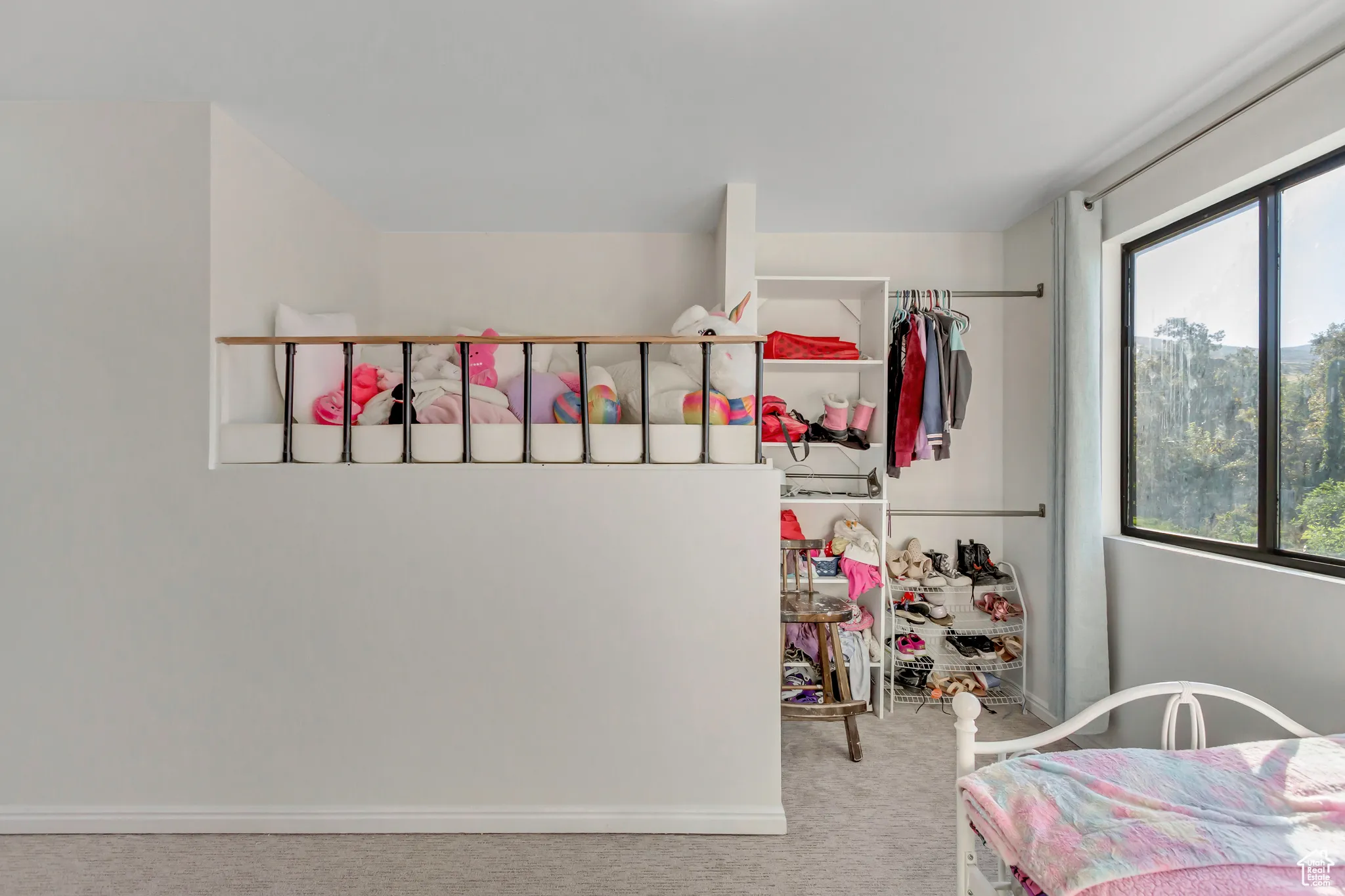 Bedroom featuring light carpet and baseboards