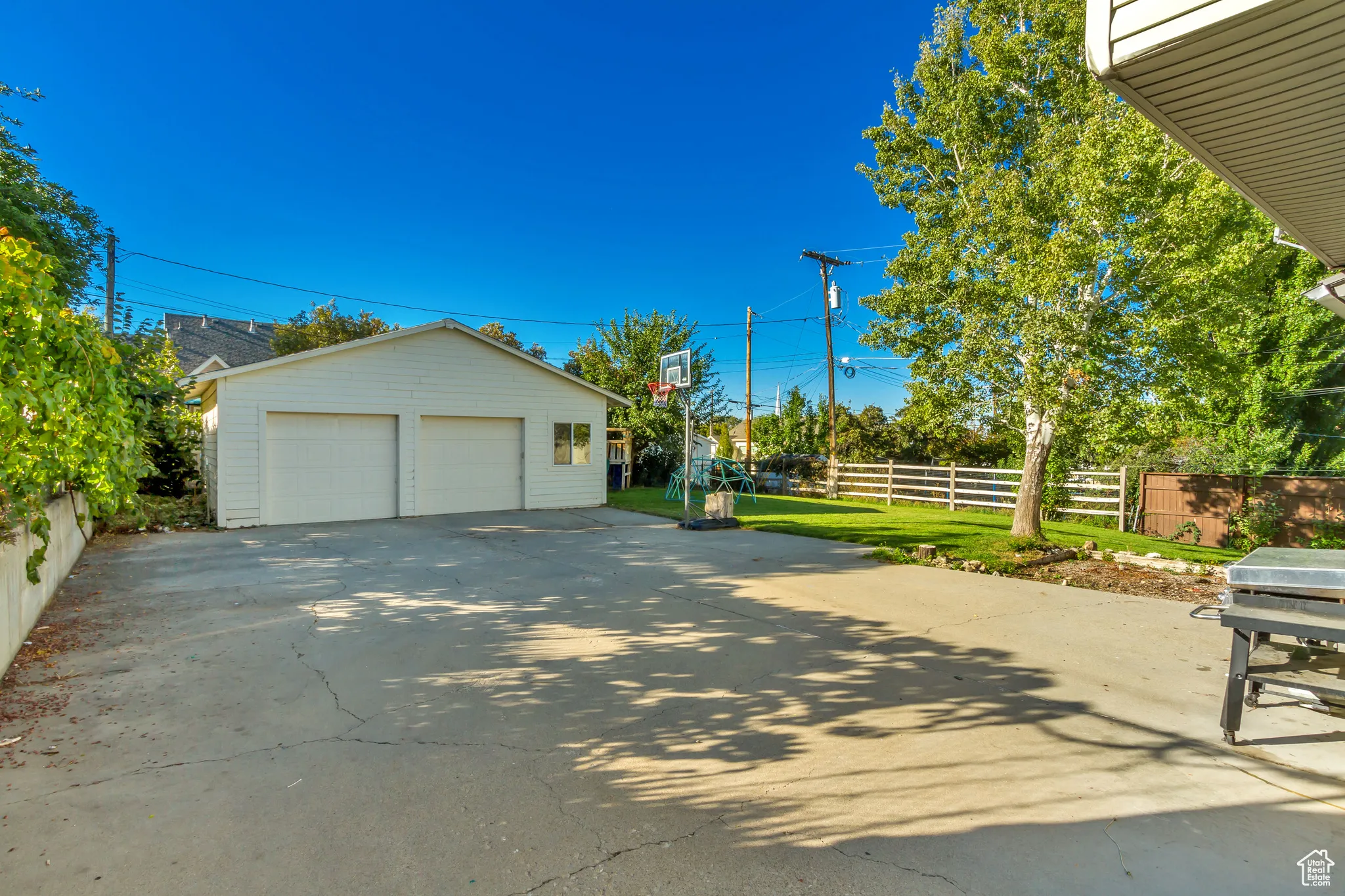 View of side of property with an outbuilding and a detached garage