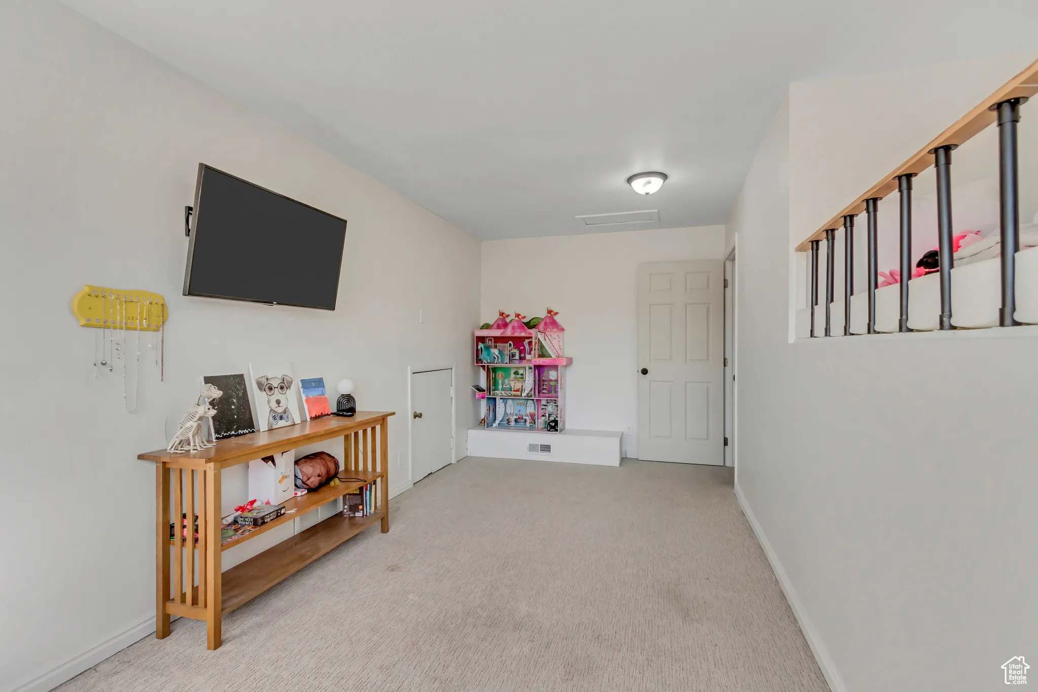Recreation room featuring light carpet and baseboards