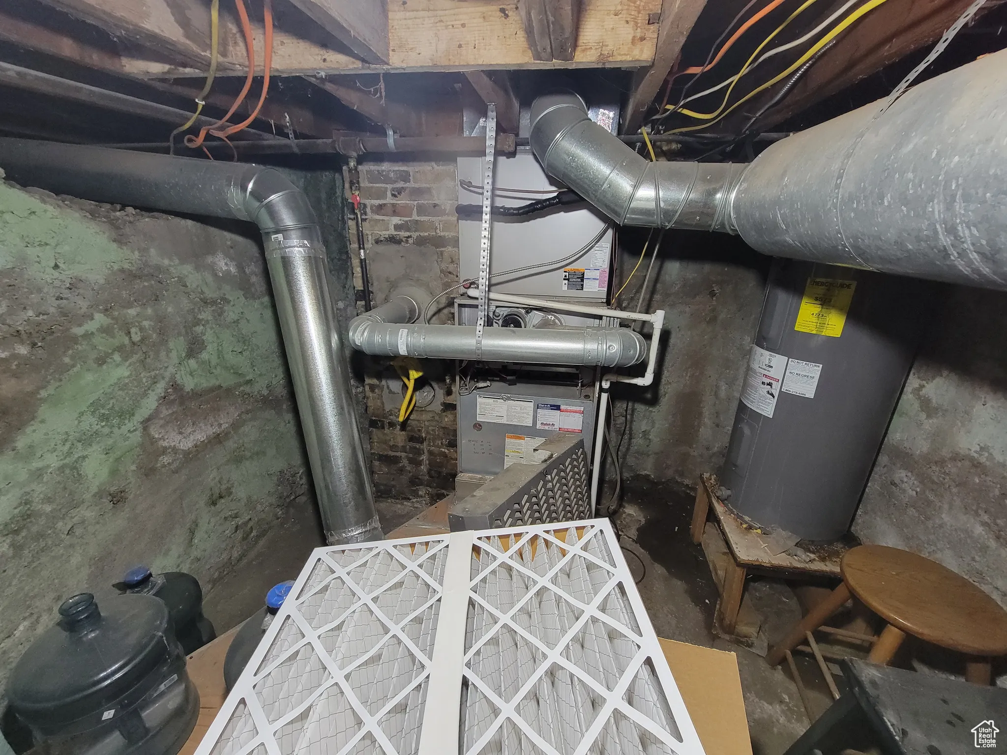 Utility room with electric water heater and heating unit