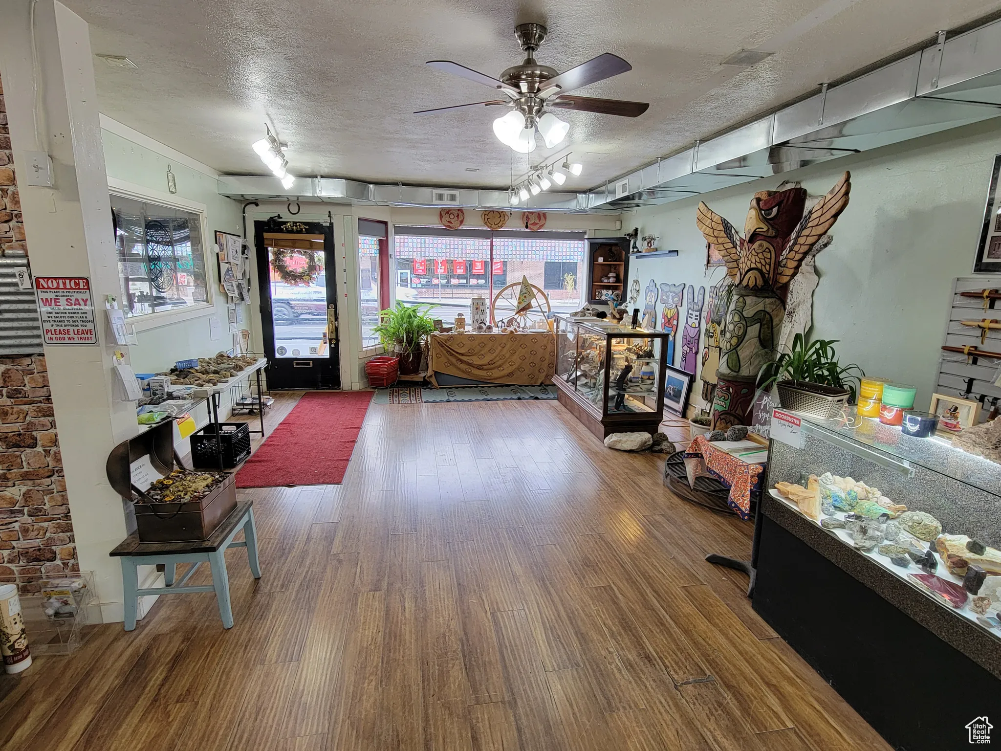 Entrance to showroom with a textured ceiling and ceiling fan